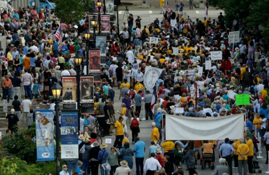 People gather during the first Moral Monday protest of the new year at Bicentennial Mall near the Legislative Building in Raleigh, N.C., Monday, May 19, 2014. (AP Photo/Gerry Broome)