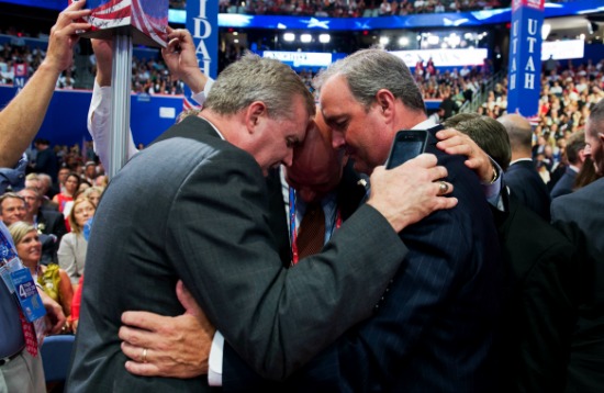 On left, Chad Connelly prays on the floor of the 2012 Republican National Convention. (Getty/Tom Williams/CQ Roll Call)