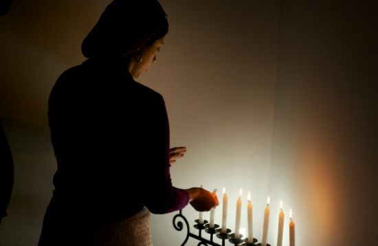 (Getty/Paul Smith/For the Washington Post) A Jewish convert lights candles in her home to mark the Sabbath. 