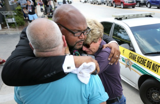 (Joe Burbank/Orlando Sentinel/TNS via Getty Images) Kelvin Cobaris, a local clergyman, consoles Orlando City Commissioner Patty Sheehan, right, and Terry DeCarlo, an Orlando gay rights advocate, as they arrive on the scene near Pulse nightclub in Orlando on June 12. 
